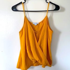 Mustard colored spaghetti strap blouse.